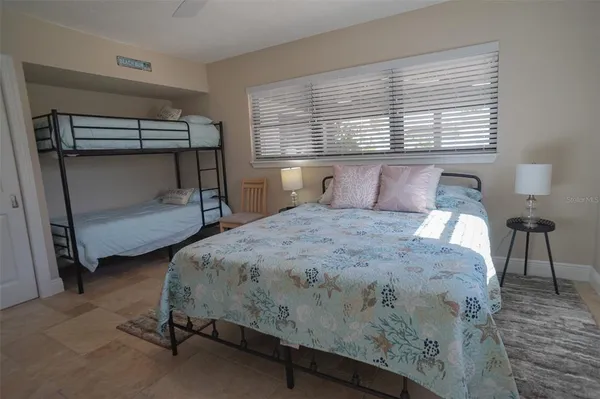 a bed sitting in a bedroom next to a window