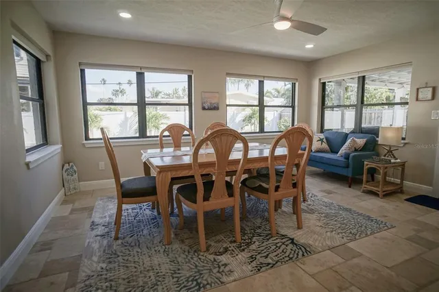 a bedroom with a bed a mirror and a window