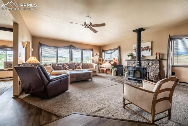 a living room with furniture a ceiling fan and a rug