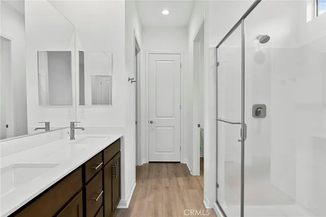 a bathroom with a double vanity sink and mirror