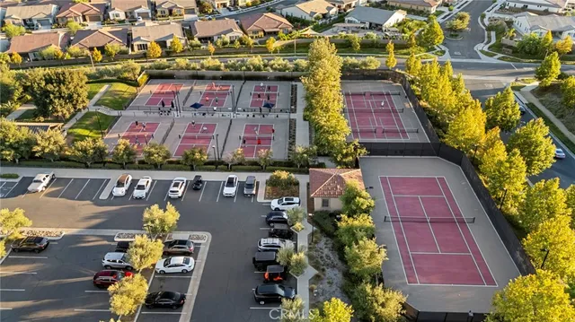 an aerial view of residential houses and car parked