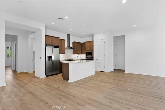 a view of large kitchen with stainless steel appliances kitchen island
