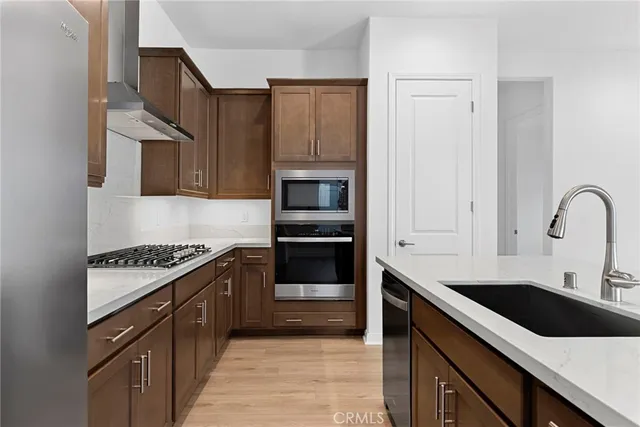 a kitchen with a sink cabinets and stainless steel appliances