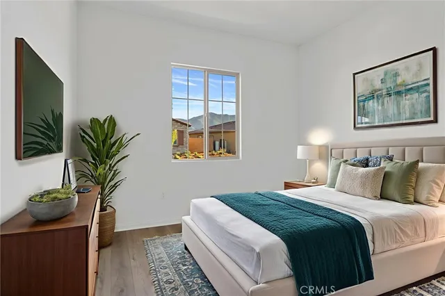 a bedroom with bed and a potted plant