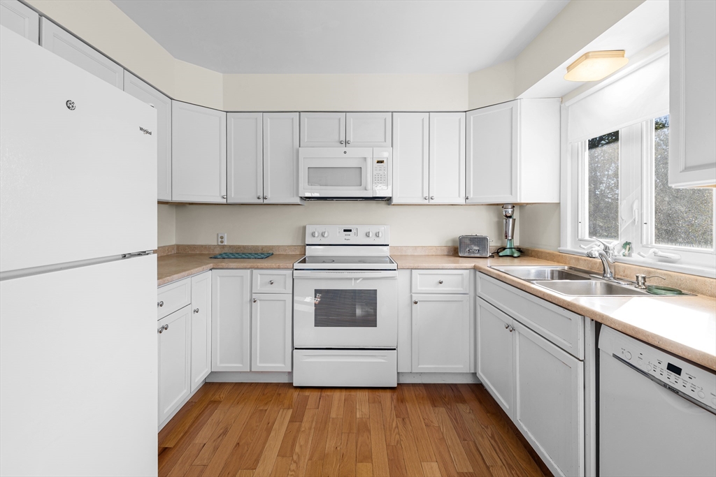 71 Harding Road Fairhaven, MA 02719 - Photo 16 of 28 a kitchen with a white cabinets sink and white appliances
