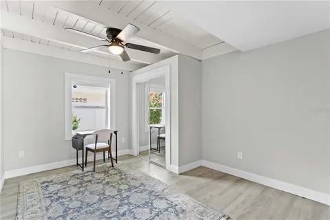 a view of a livingroom with furniture and chandelier fan