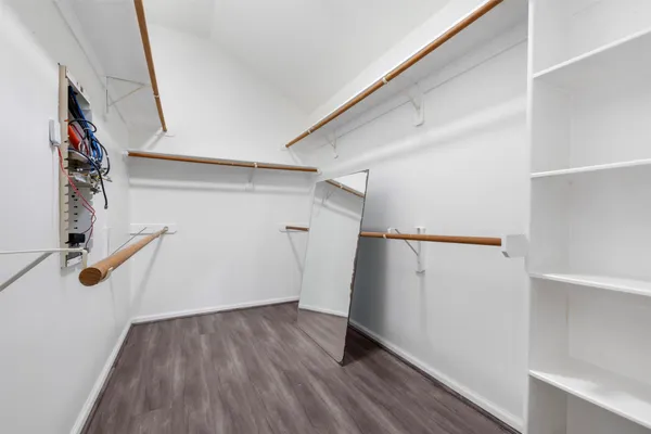 a view of a room with wooden floor and white walls