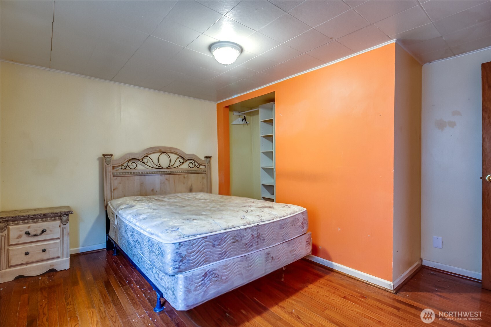 9817 35th Avenue Southwest Seattle, WA 98126 - Photo 11 of 25 a bedroom with a bed and wooden floor