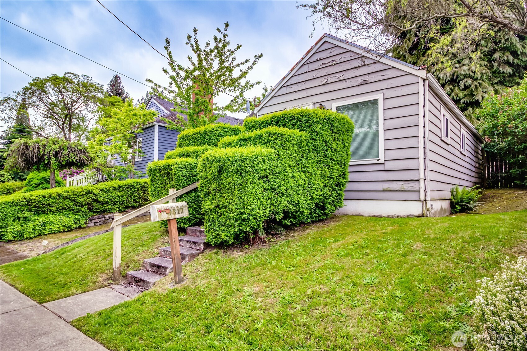 9817 35th Avenue Southwest Seattle, WA 98126 - Photo 16 of 25 a front view of a house with a yard