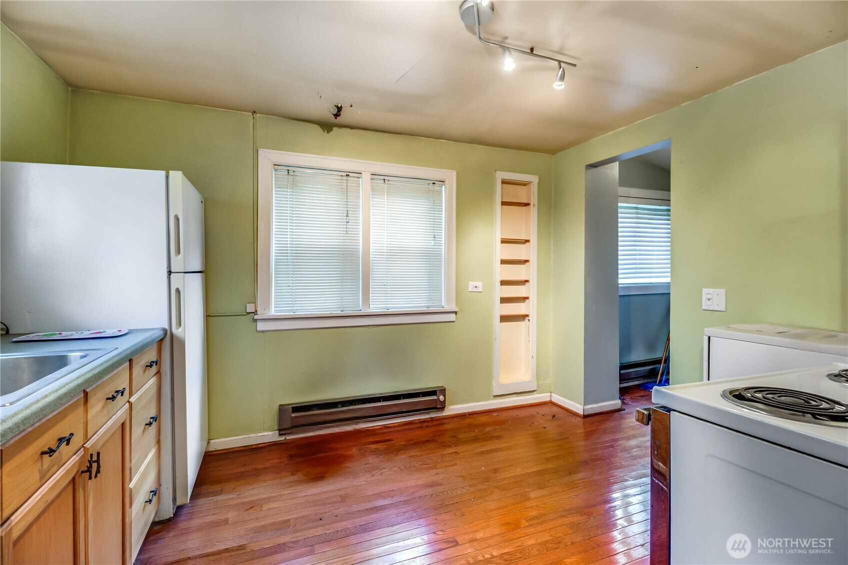 9817 35th Avenue Southwest Seattle, WA 98126 - Photo 3 of 25 a kitchen with a wooden floor and a stove top oven