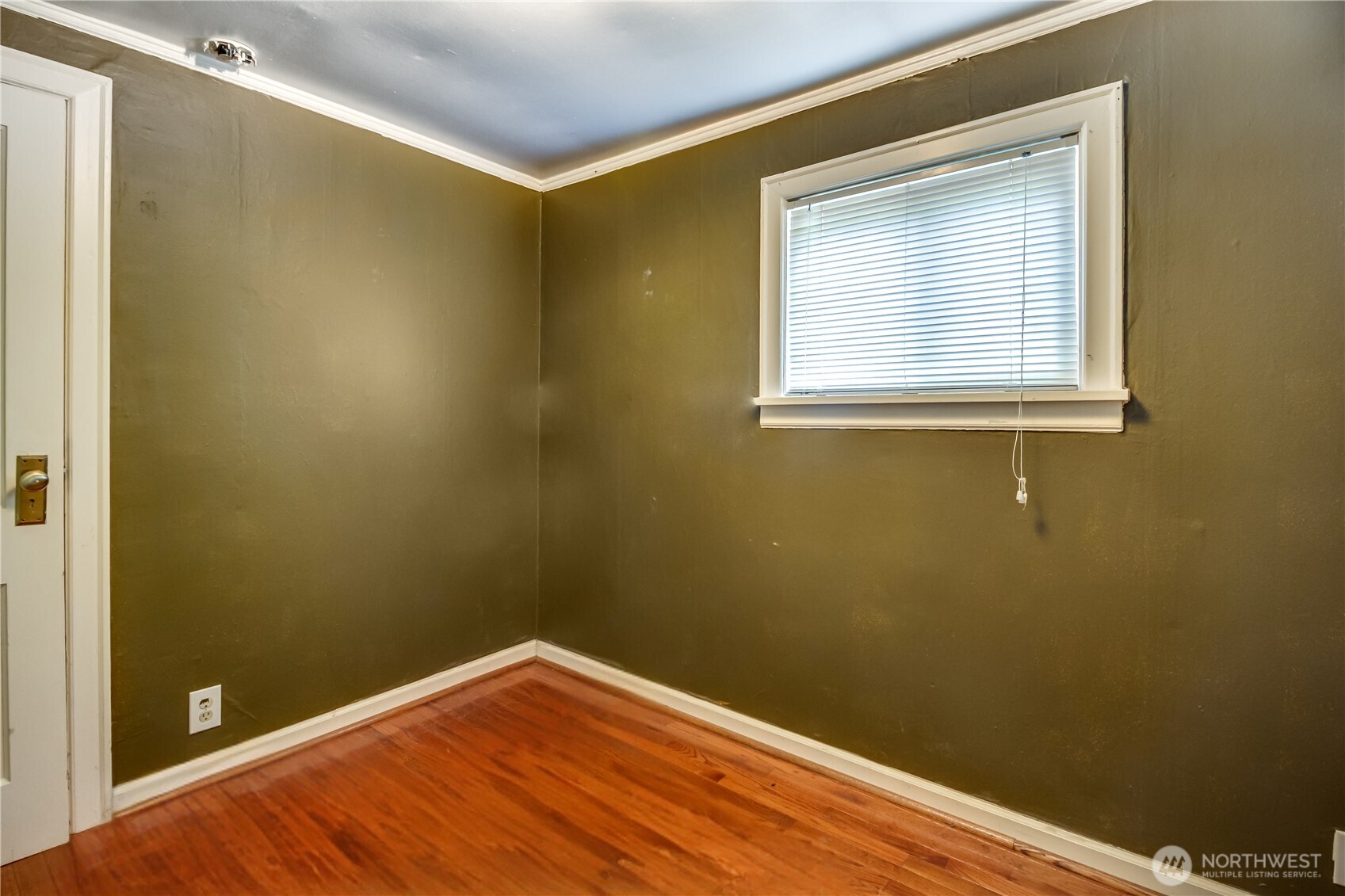 9817 35th Avenue Southwest Seattle, WA 98126 - Photo 6 of 25 a view of a small space with wooden floor and a window
