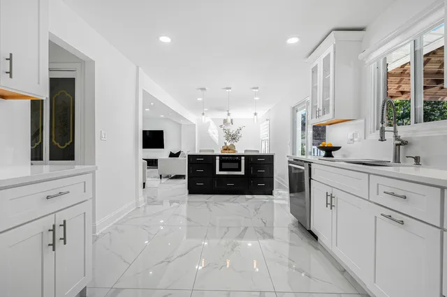 a large bathroom with a large tub and sink