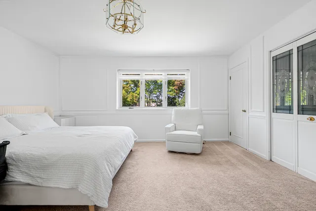 a bedroom with bed and window