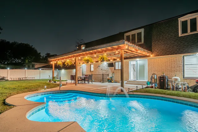 a view of a patio with a table and chairs