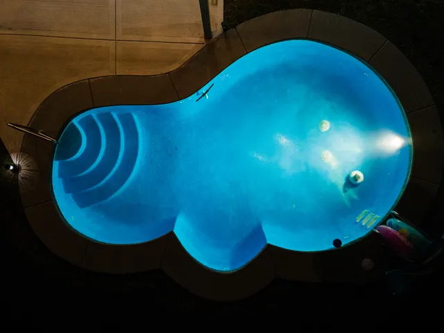 a view of a swimming pool with a yard