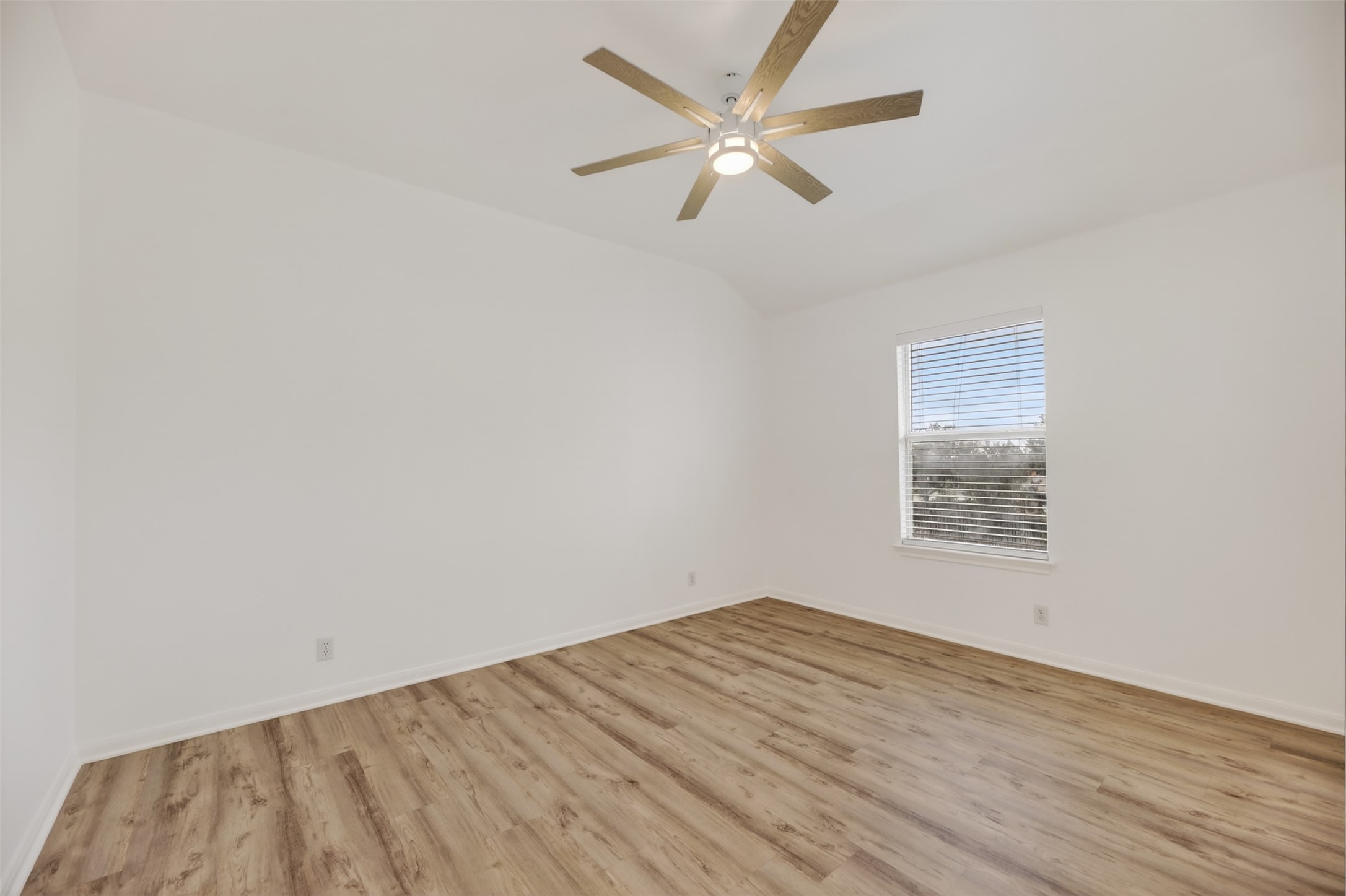 545 Manchester Lane Austin, TX 78737 - Photo 21 of 30 an empty room with wooden floor and windows