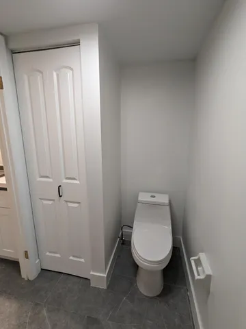 a spacious bathroom with a granite countertop sink a mirror and a shower