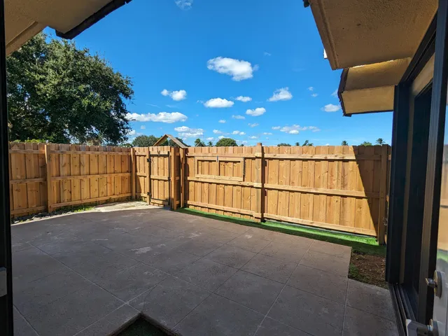 a view of an empty room with a tree