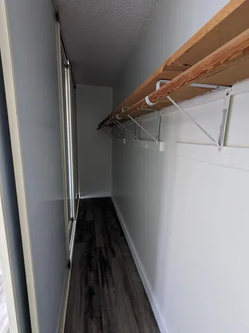 a view of a room with wooden floor