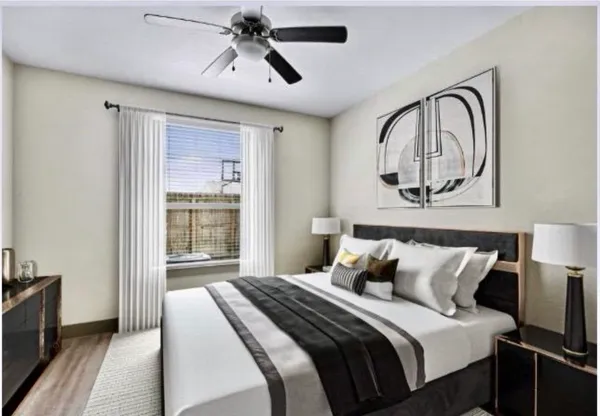 a bedroom with a large bed and a chandelier