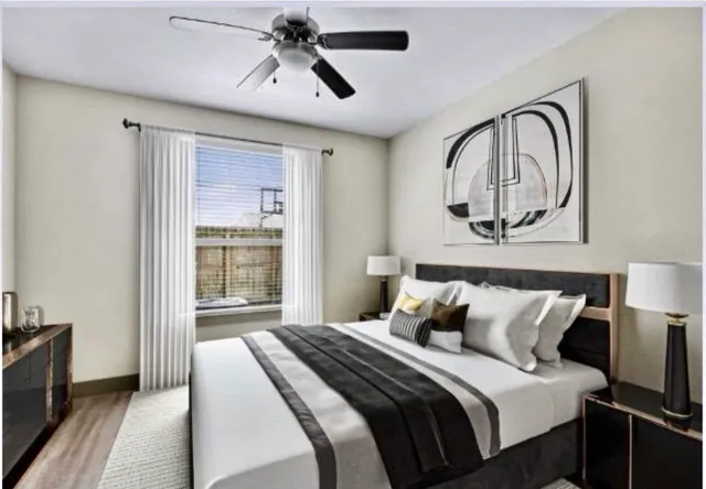 a bedroom with a large bed and a chandelier