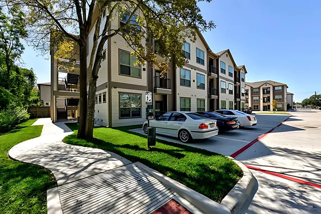 a front view of a residential apartment building with a yard
