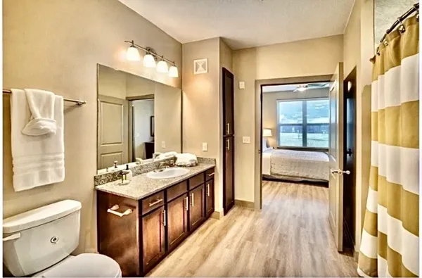 a bathroom with a toilet a sink and a mirror