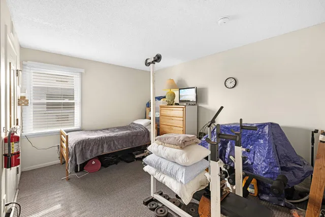 a bedroom with bed and a window