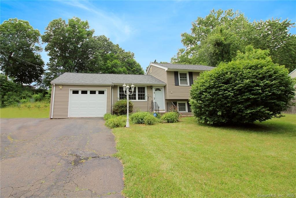 8 Ridgeland Road Wallingford, CT 06492 - Photo 1 of 1 a front view of a house with a yard and garage