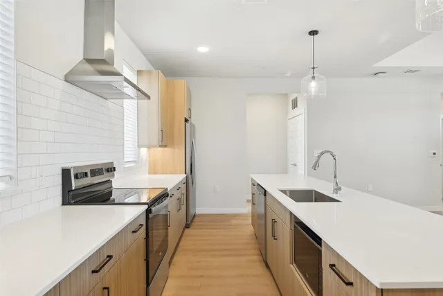 a kitchen with a sink and a stove top oven