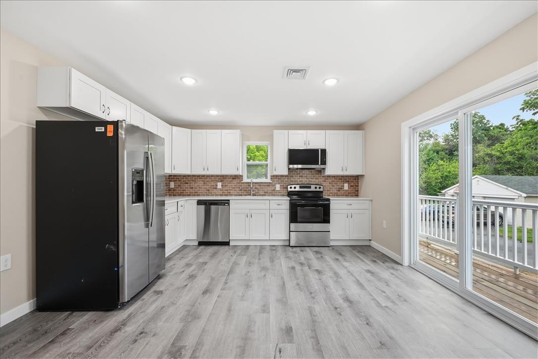 5641 North Coplay Road Whitehall, PA 18052 - Photo 2 of 68 A well-equipped kitchen awaits, featuring a full suite of stainless steel appliances and access to an outdoor deck.