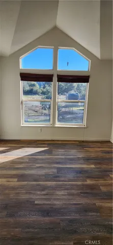 a living room with a bed and a window