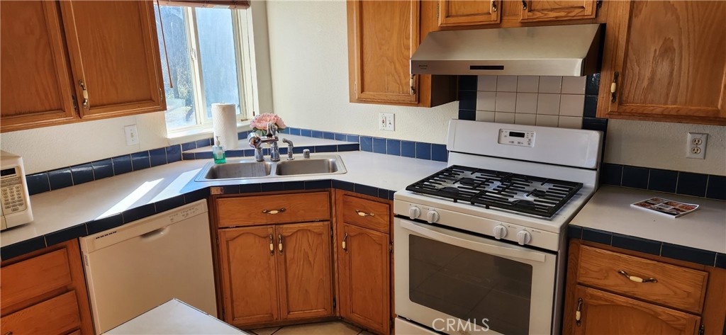 238 Elams Ranch Road Oroville, CA 95966 - Photo 24 of 75 a kitchen with granite countertop a sink stove and cabinets