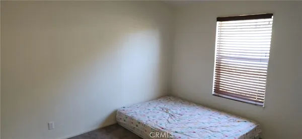 a view of a swimming pool with an outdoor seating and a forest