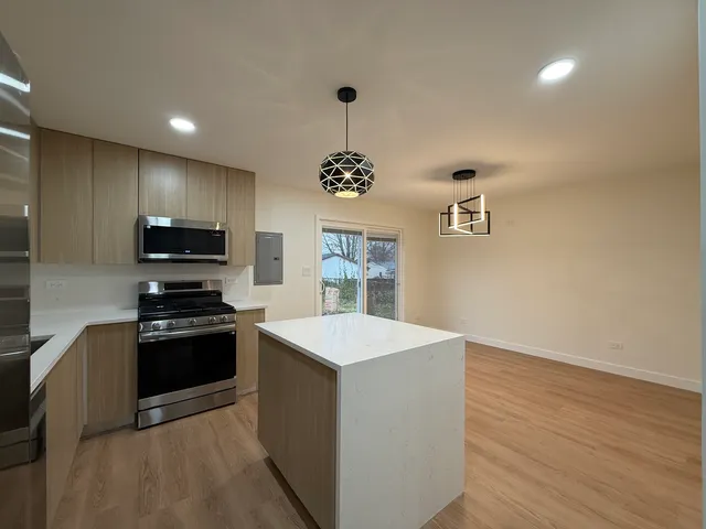 a kitchen with granite countertop a stove and a sink