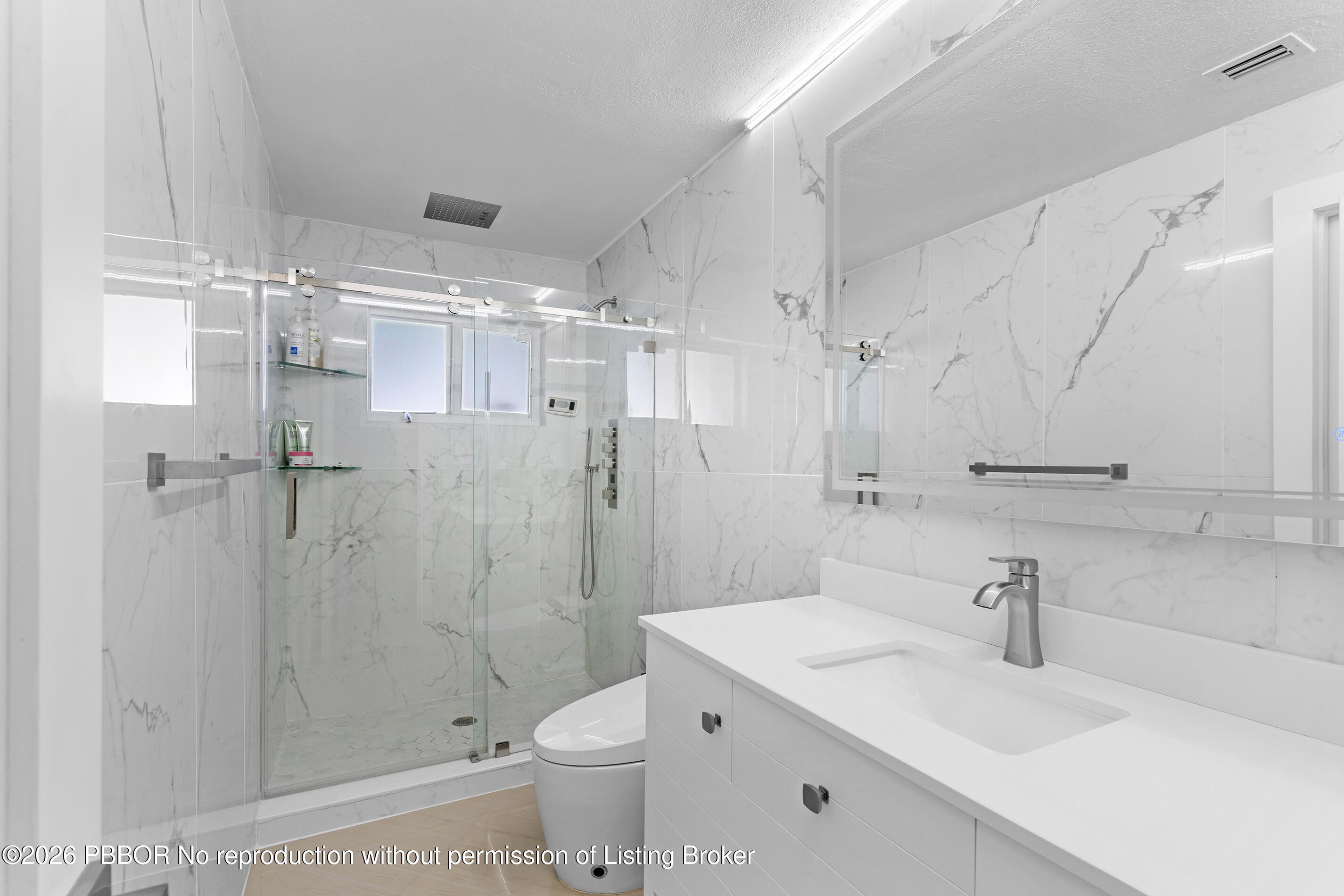 747 Avon Road West Palm Beach, FL 33401 - Photo 10 of 29 a bathroom with a sink toilet a mirror and shower