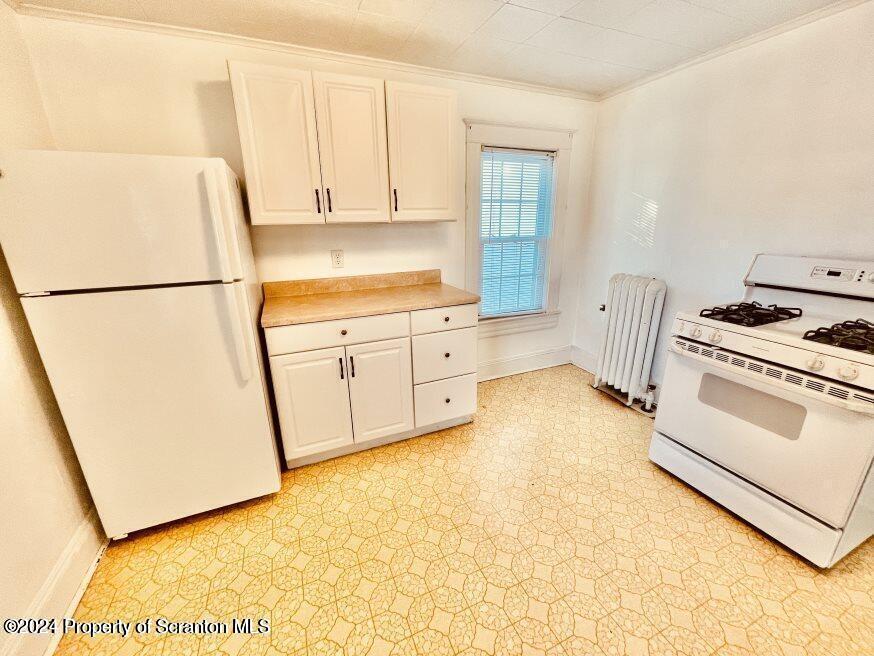 1630 Myrtle Street, Unit 2 Scranton, PA 18510 - Photo 3 of 17 a kitchen with white cabinets and white appliances