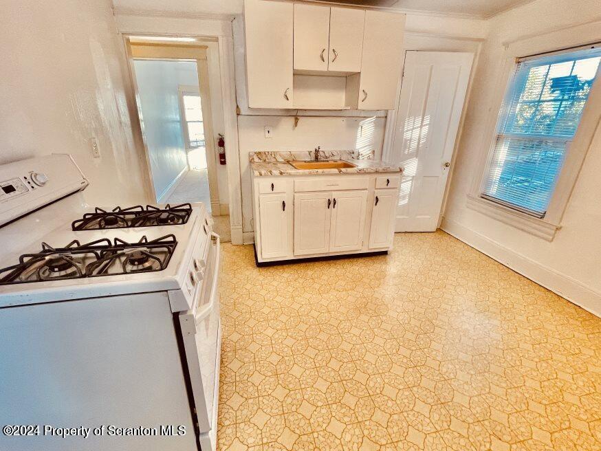 1630 Myrtle Street, Unit 2 Scranton, PA 18510 - Photo 4 of 17 a kitchen with a stove a sink and a refrigerator