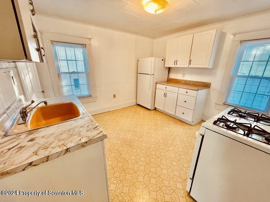 1630 Myrtle Street, Unit 2 Scranton, PA 18510 - Photo 5 of 17 a kitchen with stainless steel appliances granite countertop a sink stove and refrigerator