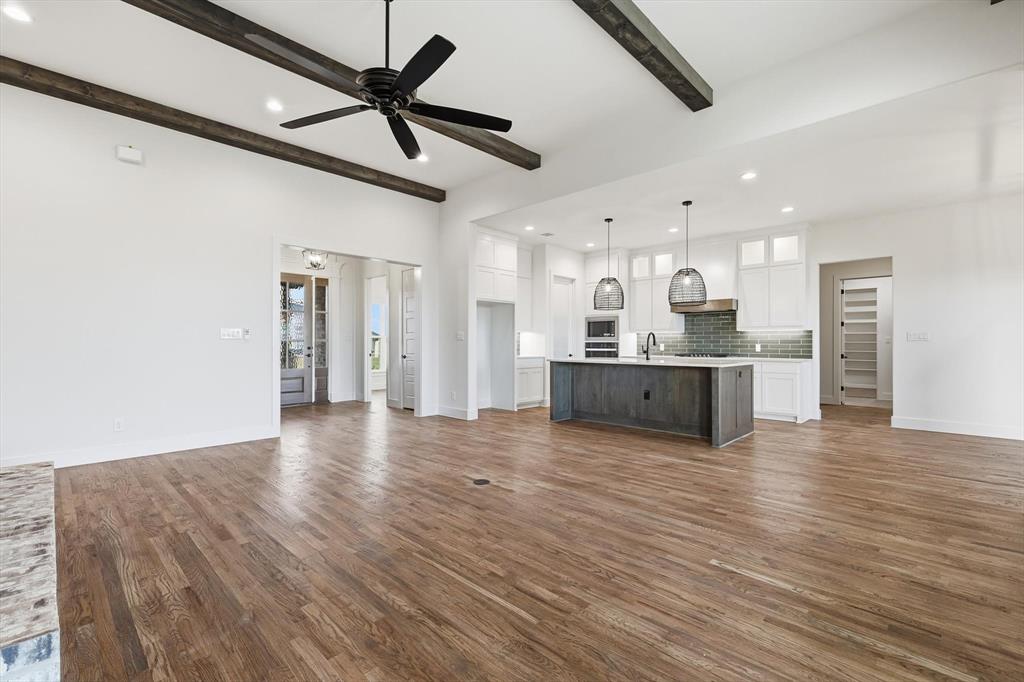6412 Rigel Road Godley, TX 76044 - Photo 12 of 38 a view of a kitchen with a sink and a refrigerator