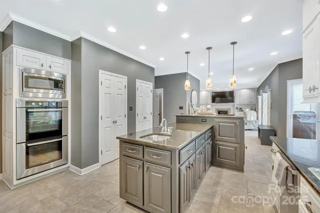a kitchen with stainless steel appliances granite countertop a sink and cabinets