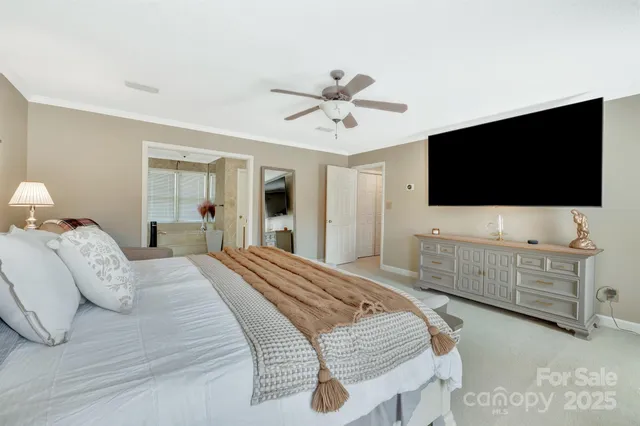 a spacious bedroom with a bed and lamp