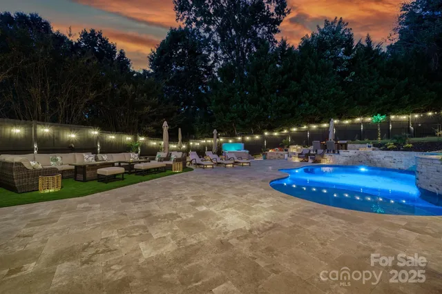 a view of a backyard with plants and outdoor seating