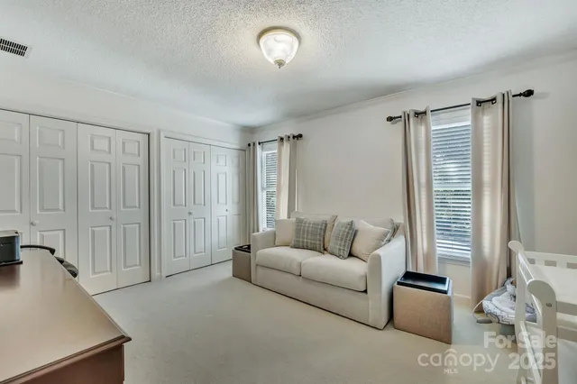 a living room with furniture a red couch and a flat screen tv