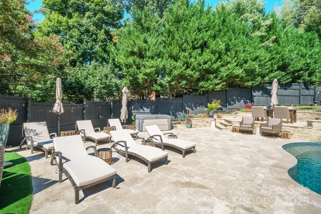 a view of backyard with seating area and trees