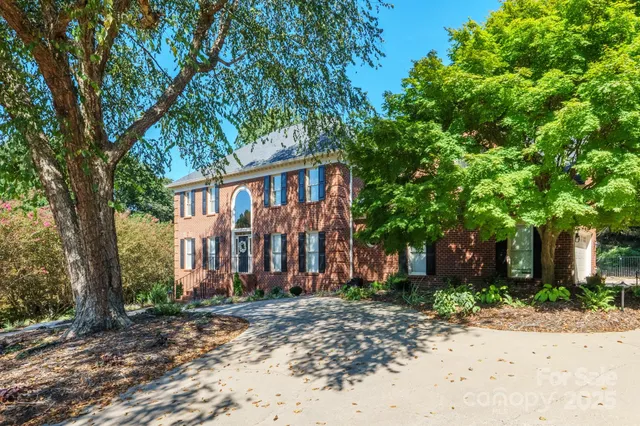 a view of a hallway with wooden floor and living room