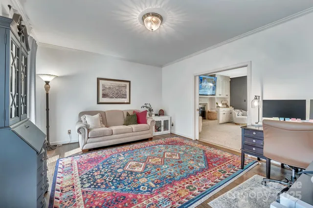a spacious bedroom with a bed and a chandelier
