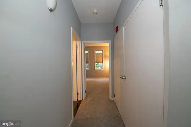 a bathroom with a granite countertop toilet sink and mirror