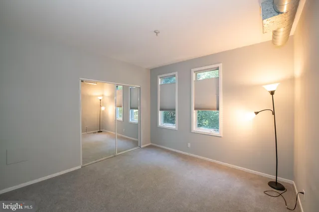 a view of a room with rack on the wall and a window