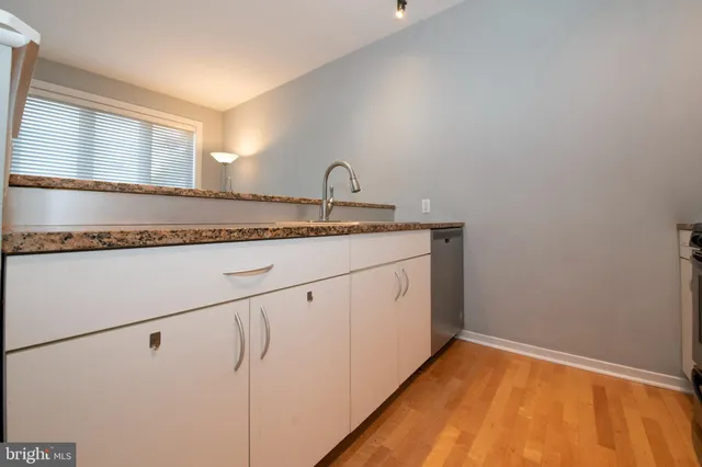 a kitchen with granite countertop a sink and a window